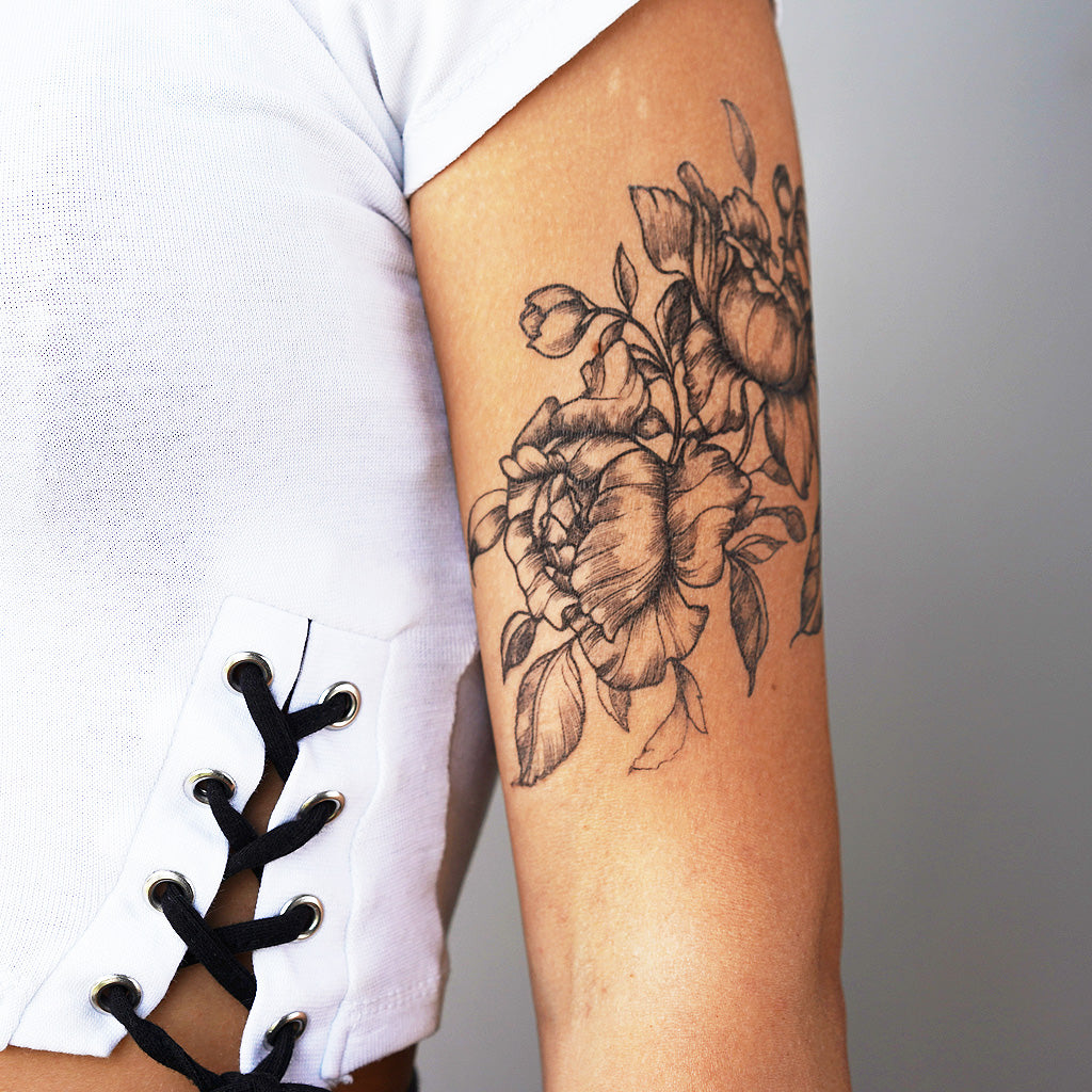 black flower arm tattoos