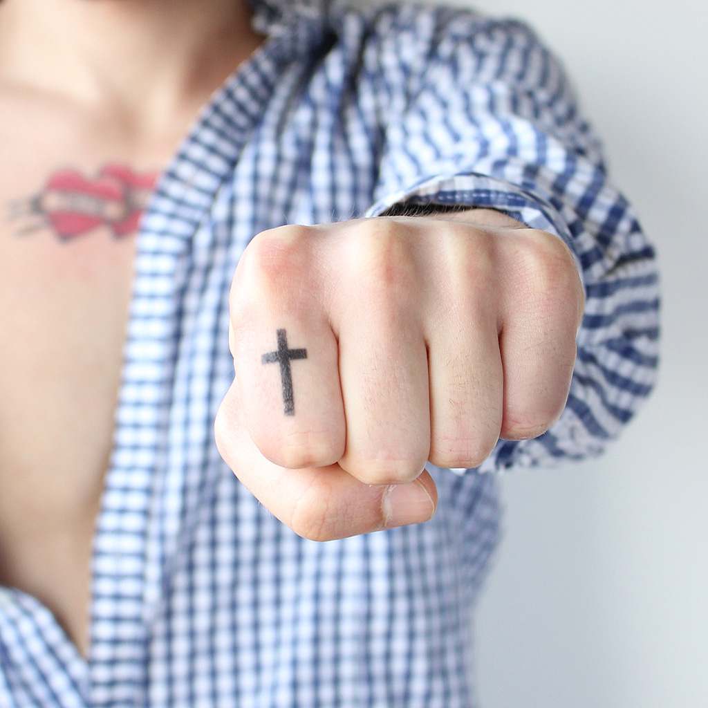cross finger tattoo