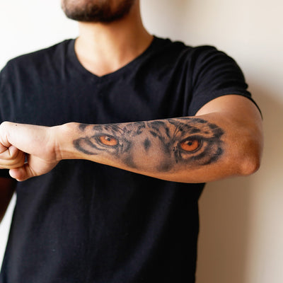 tiger eyes forearm tattoo