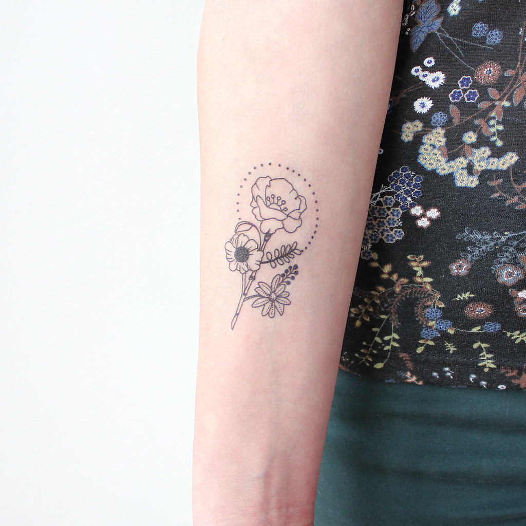 Fine line rose tattoo on the wrist