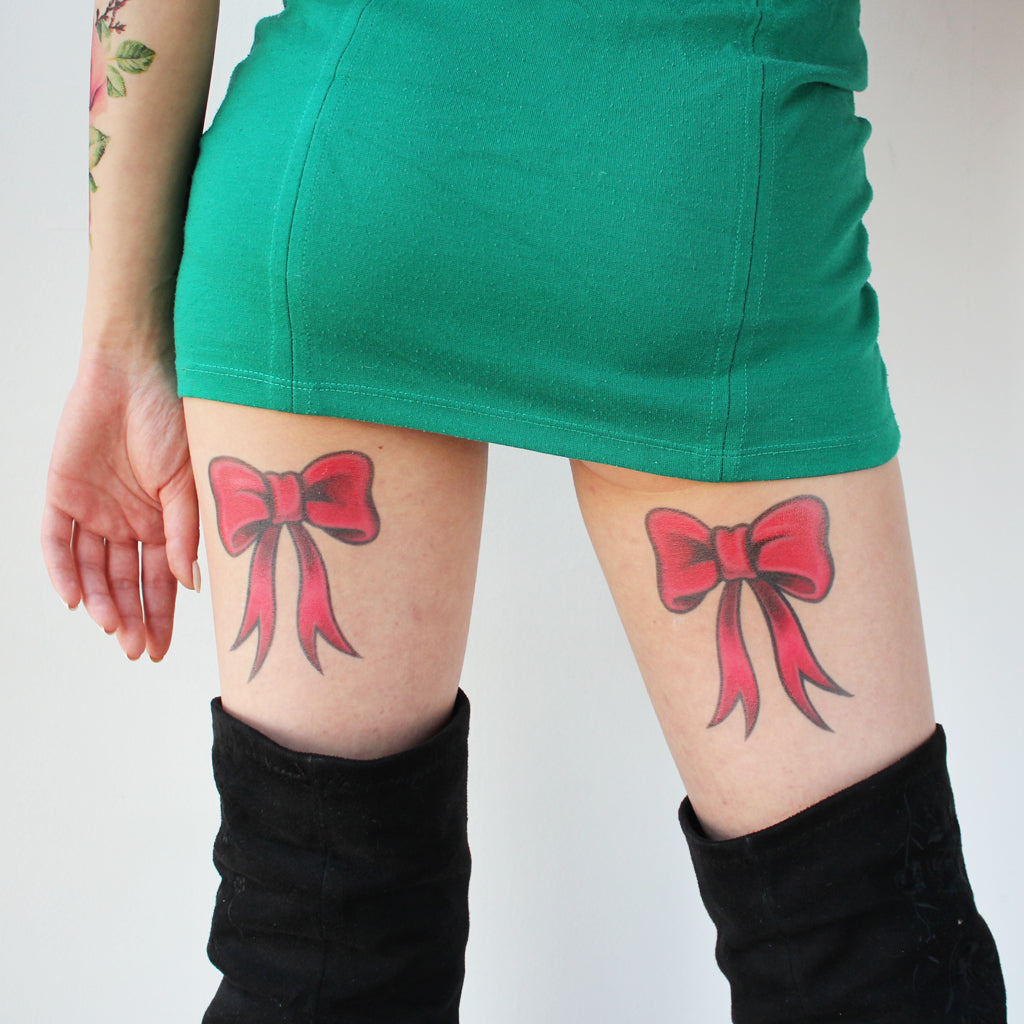 back of thigh bow tie tattoo