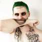 joker arm smile tattoo