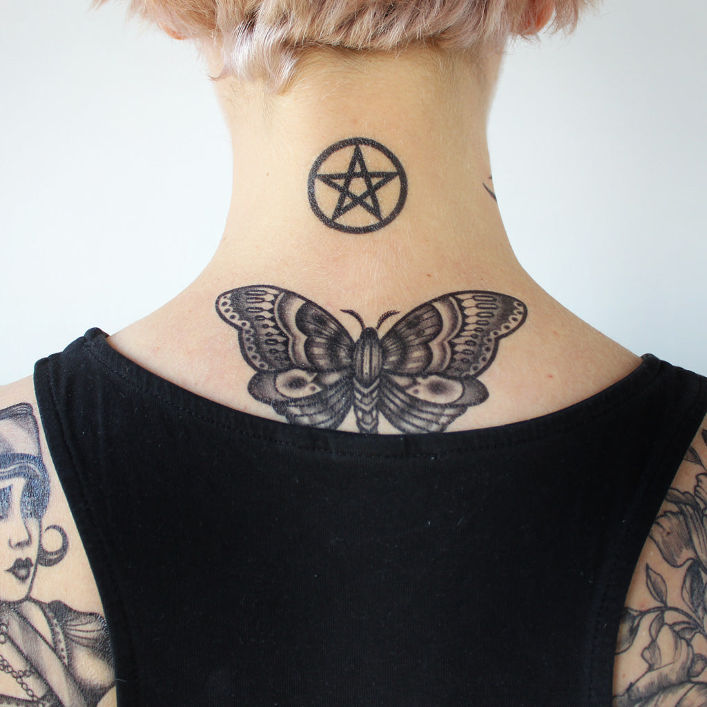 Traditional butterfly neck tattoo female with symbol