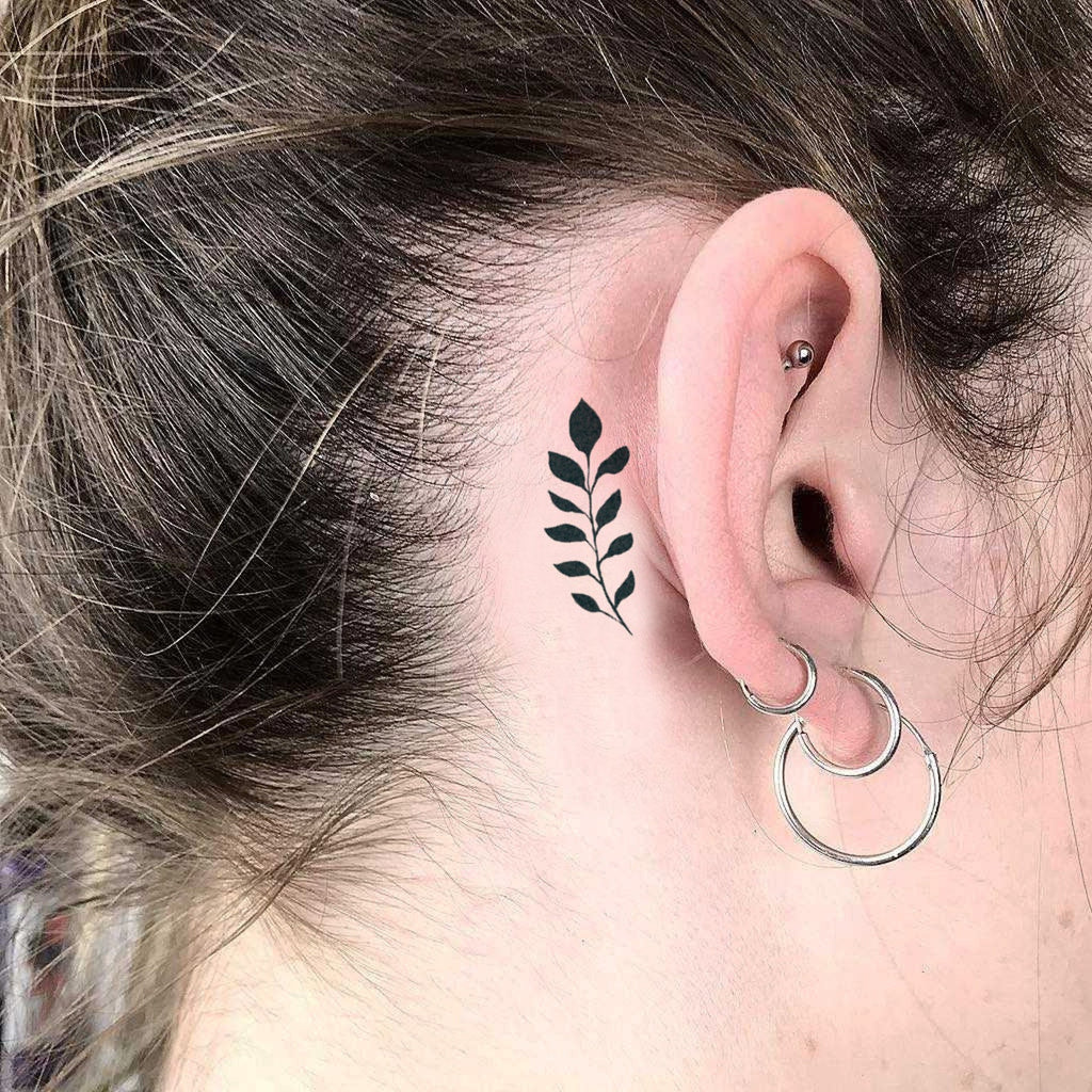 Tattoo of two hands wrapped in a delicate leaf design.